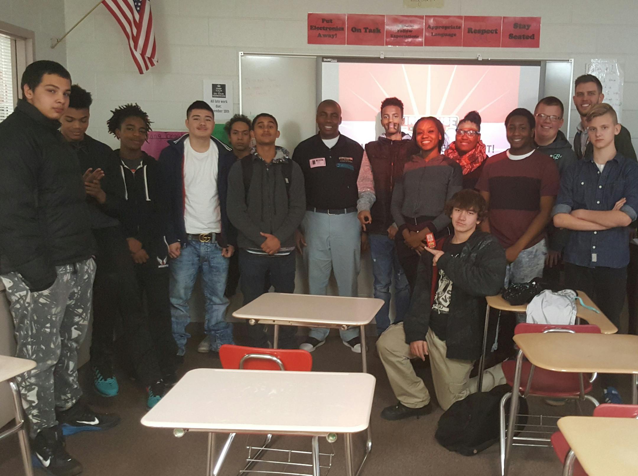 Ron Harris, (center wearing badge) who started out at minimum wage in a Taco Bell in suburban Chicago after high school, meets regularly with students at North St. Paul High School and otherwise to talk about education, work and attitude. Harris, 50, is the Minnesota area director and a franchisee of Firehouse Subs.