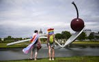 Kelly Harris, of Mound, left, stood beside his sister, Karly Boll, of Minneapolis, as they stopped by Spoonbridge Cherry Saturday while visiting Pride