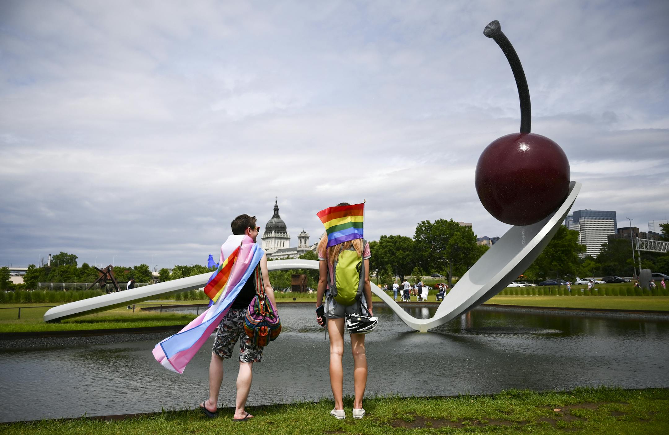 Kelly Harris, of Mound, left, stood beside his sister, Karly Boll, of Minneapolis, as they stopped by Spoonbridge Cherry Saturday while visiting Pride festivities across the freeway at Loring Park. "This is my first pride," said Harris, who just came out of the closet this year. The event makes Harris feel "so much less alone" knowing there are others out there like him.
] Aaron Lavinsky &#xa5; aaron.lavinsky@startribune.com Pride weekend is underway in Minneapolis, with a big crowd at Loring Pa
