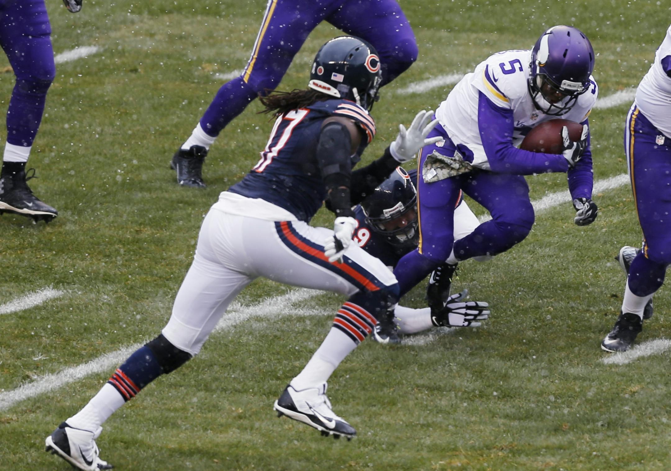 Minnesota Vikings quarterback Teddy Bridgewater (5) is tackled by Chicago Bears defensive end Jared Allen (69) during the first half of an NFL football game Sunday, Nov. 16, 2014 in Chicago. At left is Bears defensive end Willie Young (97).