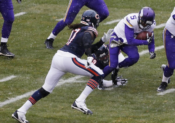 Minnesota Vikings quarterback Teddy Bridgewater (5) is tackled by Chicago Bears defensive end Jared Allen (69) during the first half of an NFL footbal