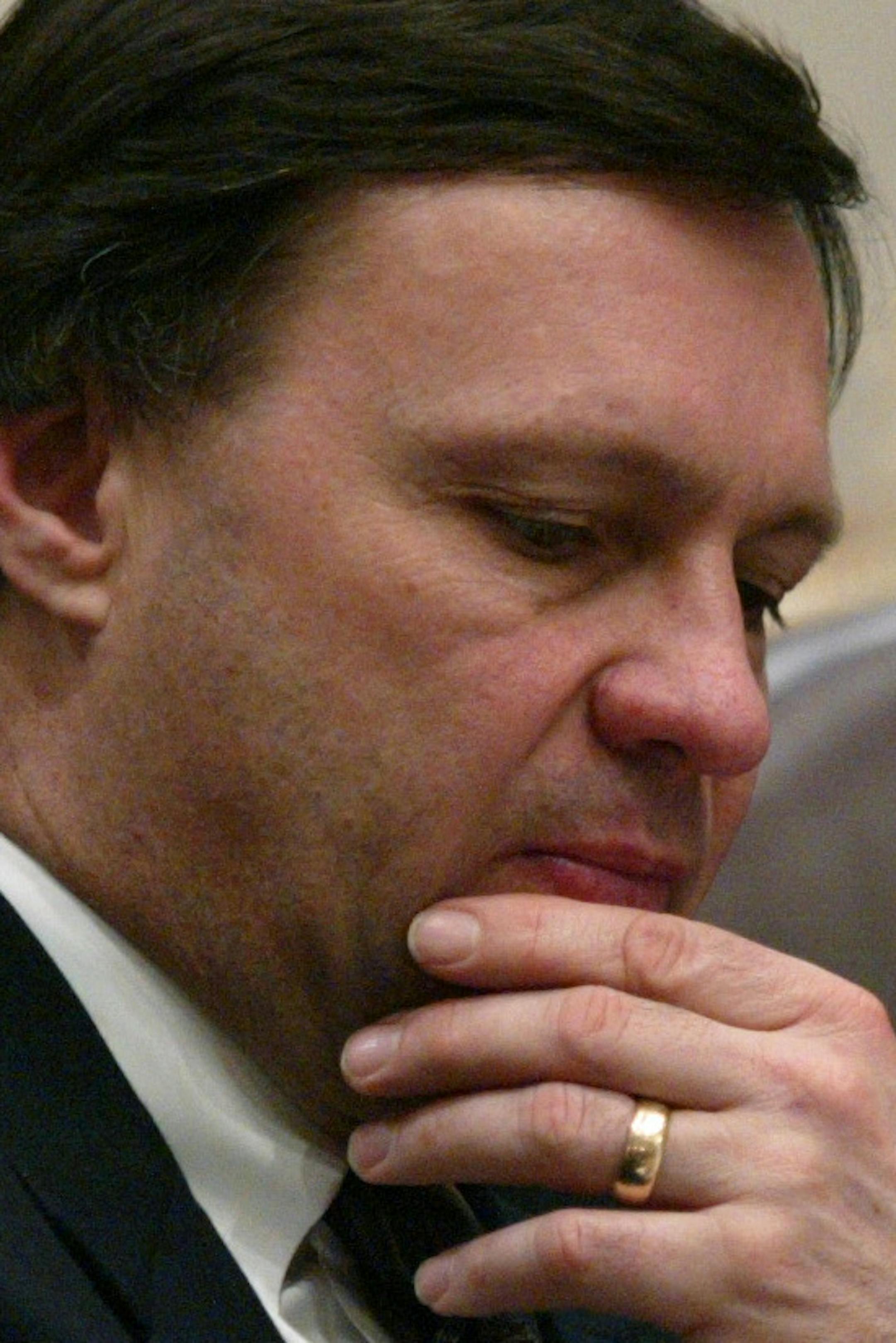 Senate Finance Committee Chairman Senator Richard Cohen, right, looks over specifics of the governor's proposed budget cuts with Mark Misukanis, center, and Peter Watson, left, during a Finance Committee meeting at the State Capitol Thursday. Governor Pawlenty plans $77 million in cuts to erase the state's $356 million deficit projected through June.