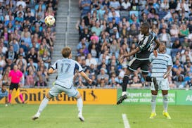 Loons forward Tani Oluwaseyi heads in a goal over Sporting Kansas City midfielder Jake Davis in the first half Saturday at Allianz Field.