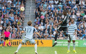Loons striker Tani Oluwaseyi heads in a goal over Sporting Kansas City midfielder Jake Davis in the 33rd minute on Saturday at Allianz Field.