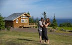 Andrew and Simone Strand held their son, Eddie, on their land in Grand Marais. They live on the property and also have a cabin that they rent out as a