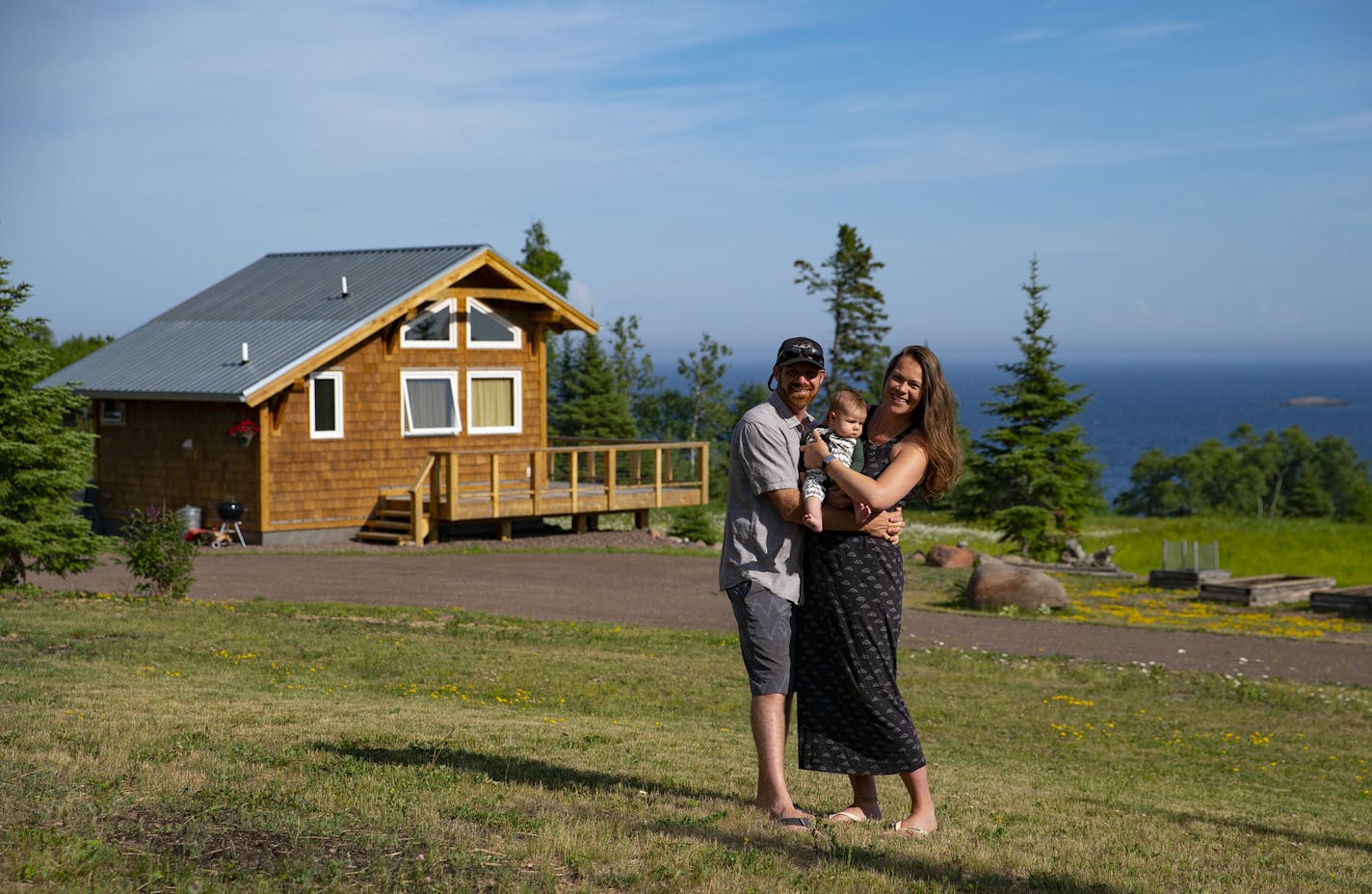 Andrew and Simone Strand held their son, Eddie, on their land in Grand Marais. They live on the property and also have a cabin that they rent out as an Airbnb.