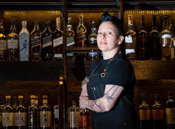 Bar director Ralena Young posed for a photo in front the the hundreds of whisky and liquor varieties at Volstead House in Eagan on Tuesday, January 15
