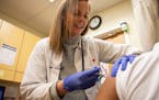 Nurse practitioner Kelly Moran gave a flu shot to a patient at a CVS Minute Clinic in Philadelphia in January 2020. 