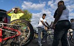 Cyclists get ready for the Slow Roll ride at Juxtaposition Arts. From left is Farji Shaheer, Jarren "J" Davis and Lamar "Bam" Ford.