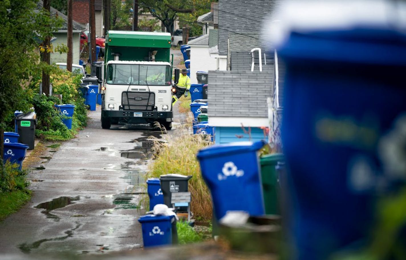 A Waste Management worker collected trash from the alleys of the Snelling-Hamline neighborhood in 2018. A Ramsey County judge on Thursday stayed his previous order suspending the program on Thursday.