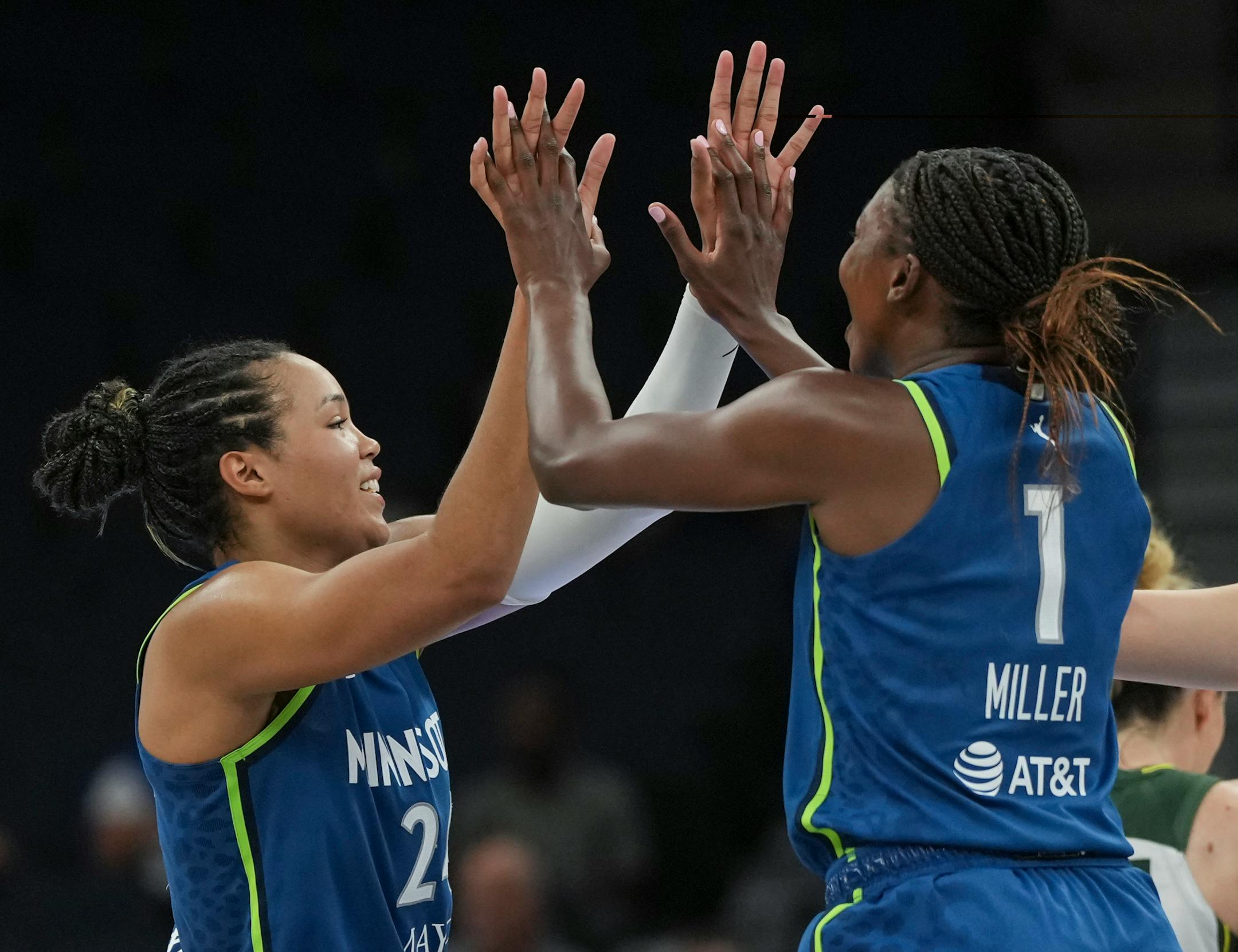 Minnesota Lynx forward Napheesa Collier (24) celebrates with Minnesota Lynx guard Diamond Miller (1) and Minnesota Lynx forward Dorka Juhasz (14) after defeating Seattle Storm 104-93 on Tuesday, June 27, 2023 at the Target Center in Minneapolis.