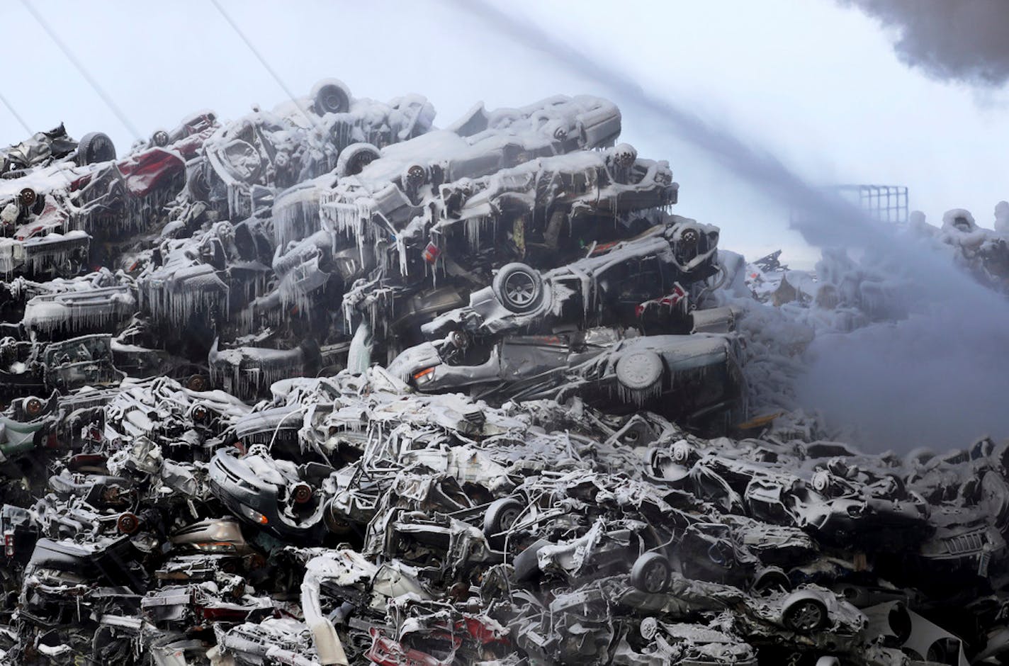 Ice-covered junk vehicles in a heap at the Northern Metal Recycling plant in Becker, Minn., on Wednesday morning.