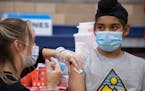 Harnoorvir Singh Jabbal, 11, got the COVID-19 vaccine from nurse Chelsea Meyer at Arleta High School on Nov. 8 in Los Angeles.