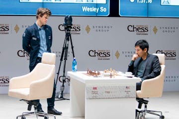 World Chess Champion Magnus Carlsen, left, looks at the board as Grandmaster Wesley So contemplates his next move at the Gashimov Memorial Tournament 