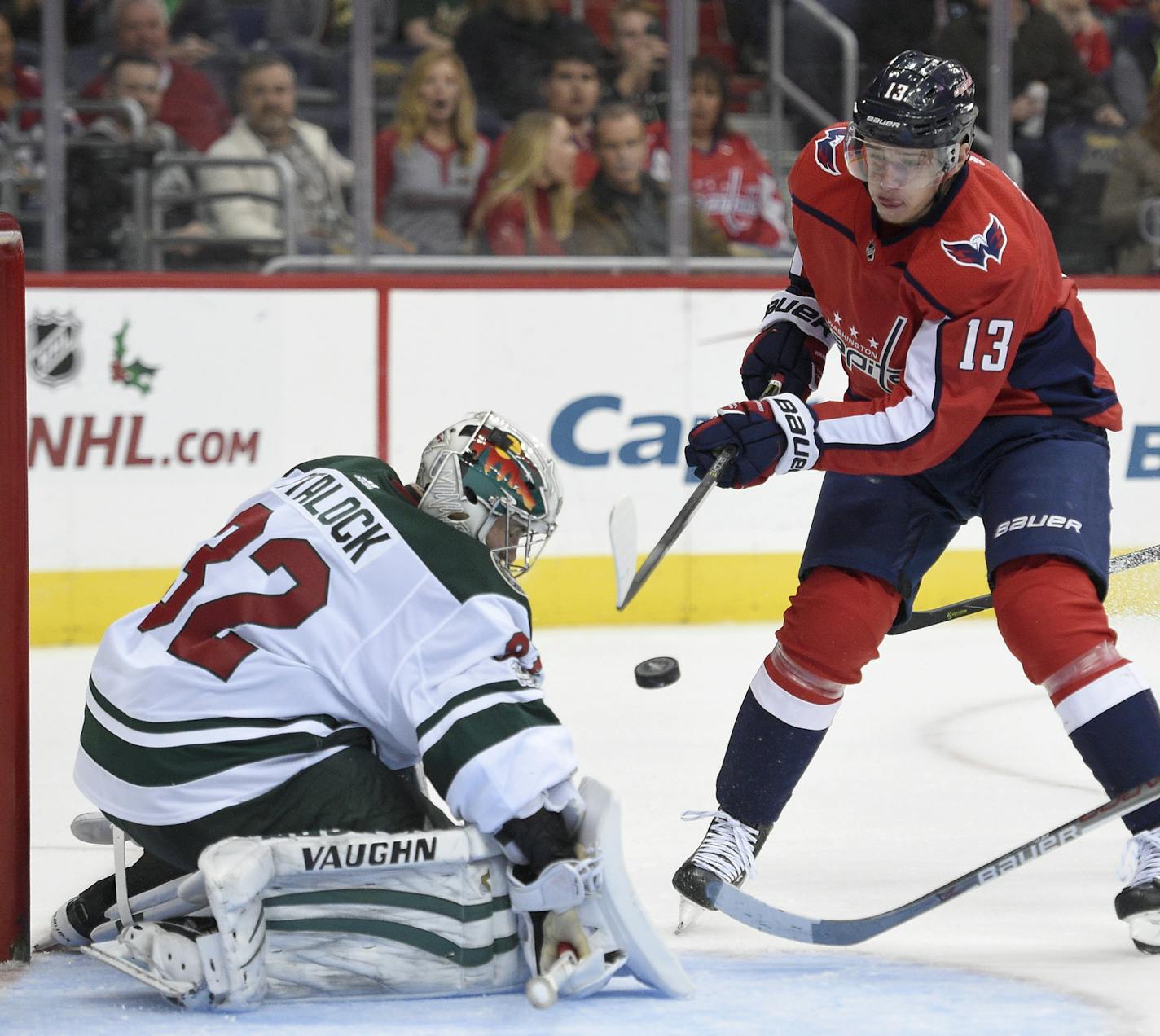 Washington Capitals left wing Jakub Vrana (13), of the Czech Republic, tries to get the puck past Minnesota Wild goalie Alex Stalock (32) during the second period of an NHL hockey game, Saturday, Nov. 18, 2017, in Washington. (AP Photo/Nick Wass)