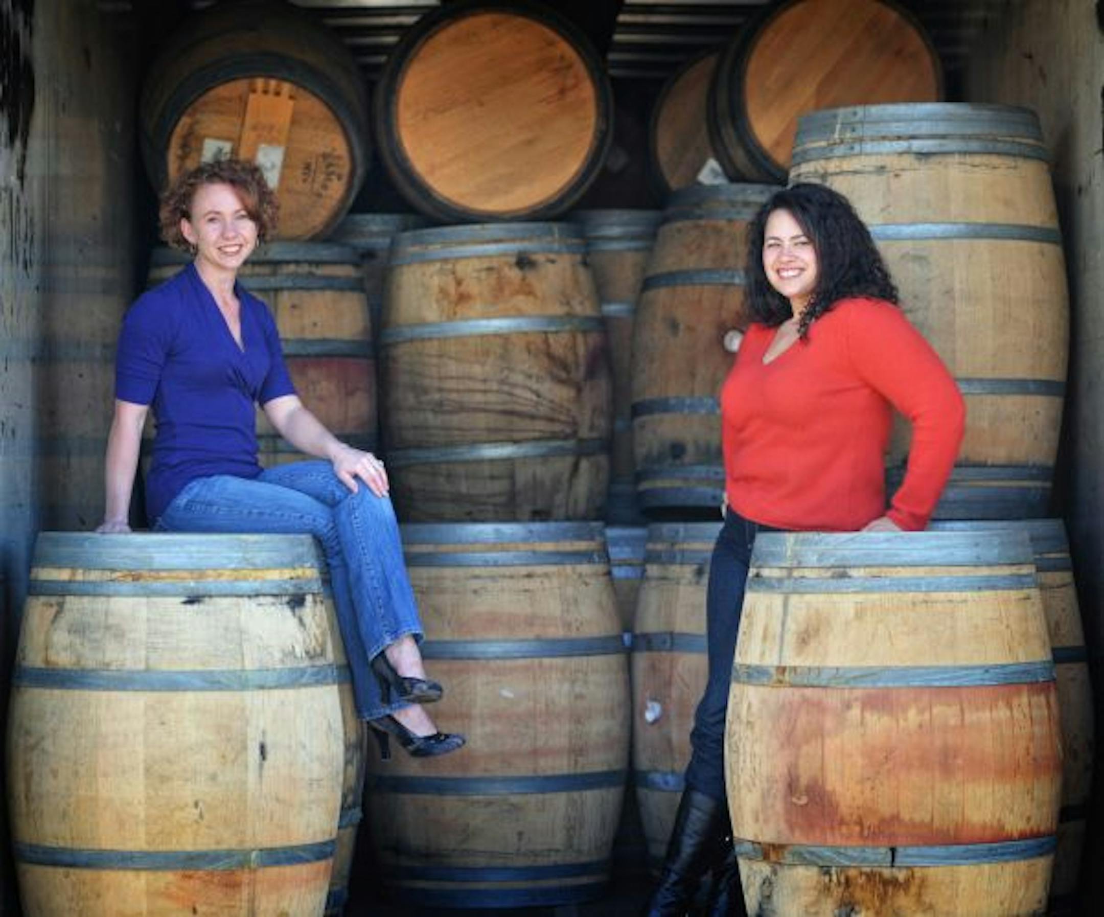 Tonya Baker, left, and Elena Kotowski roll in the barrels aboard a semitruck trailer in Shakopee.