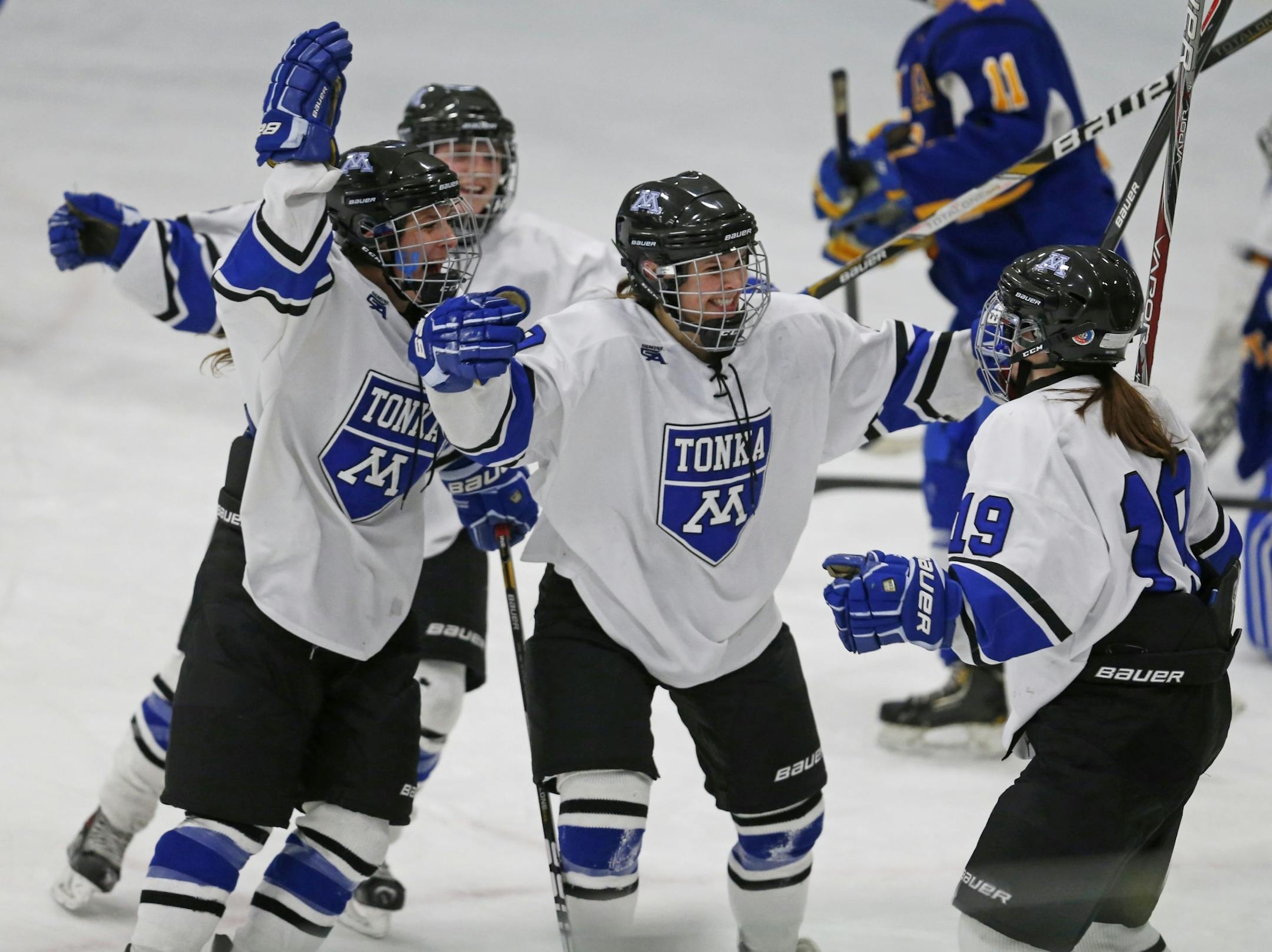 At Minnetonka H.S. in a girls hockey game against Wayzata, Minnetonka including Kelsey Crow(19), far right, celebrate their sudden death win.