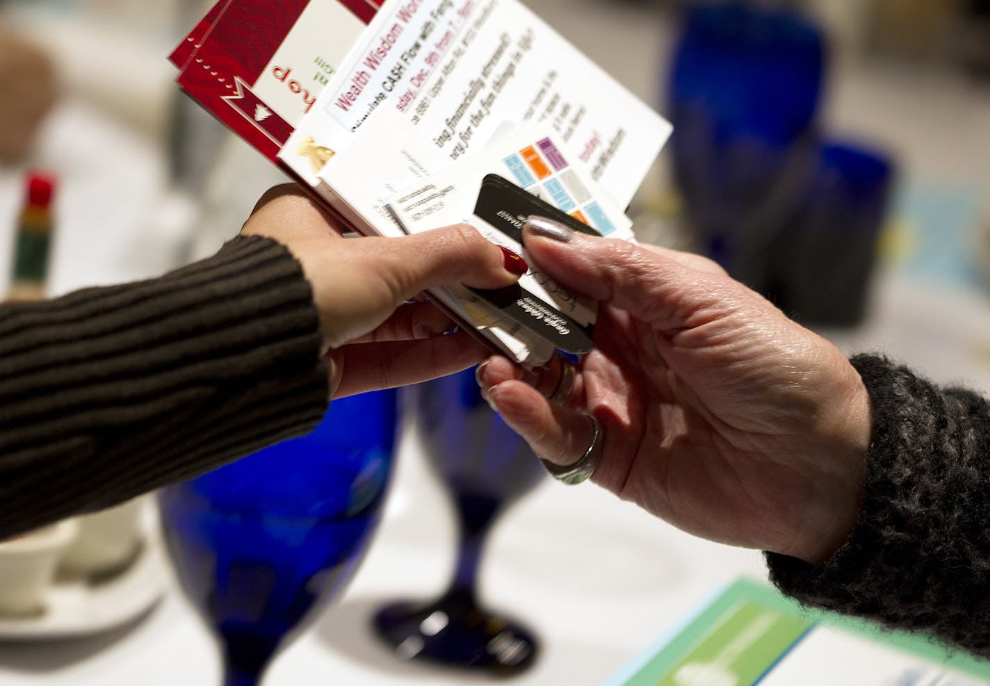 Event information and business cards are passed around during the Women in Networking (WIN) monthly breakfast at the Downtowner Woodfire Grill in St. Paul December 8, 2015. (Courtney Perry/Special to the Star Tribune)