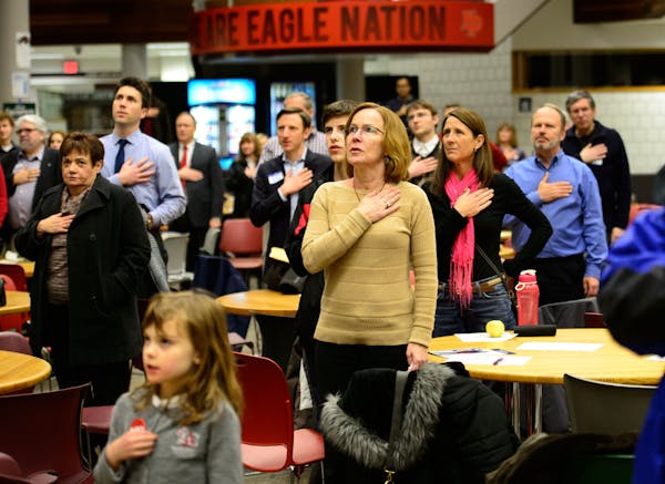 Republicans said the pledge of allegiance before the start of the caucus at Eden Prairie High School on Feb. 4, 2014.