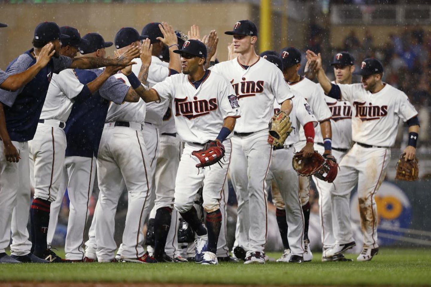 Minnesota Twins left fielder Eddie Rosario, center left, and right fielder Max Kepler, center right, celebrate with teammates after a 4-2 victory over the New York Yankees in a baseball game Monday, July 17, 2017, in Minneapolis.