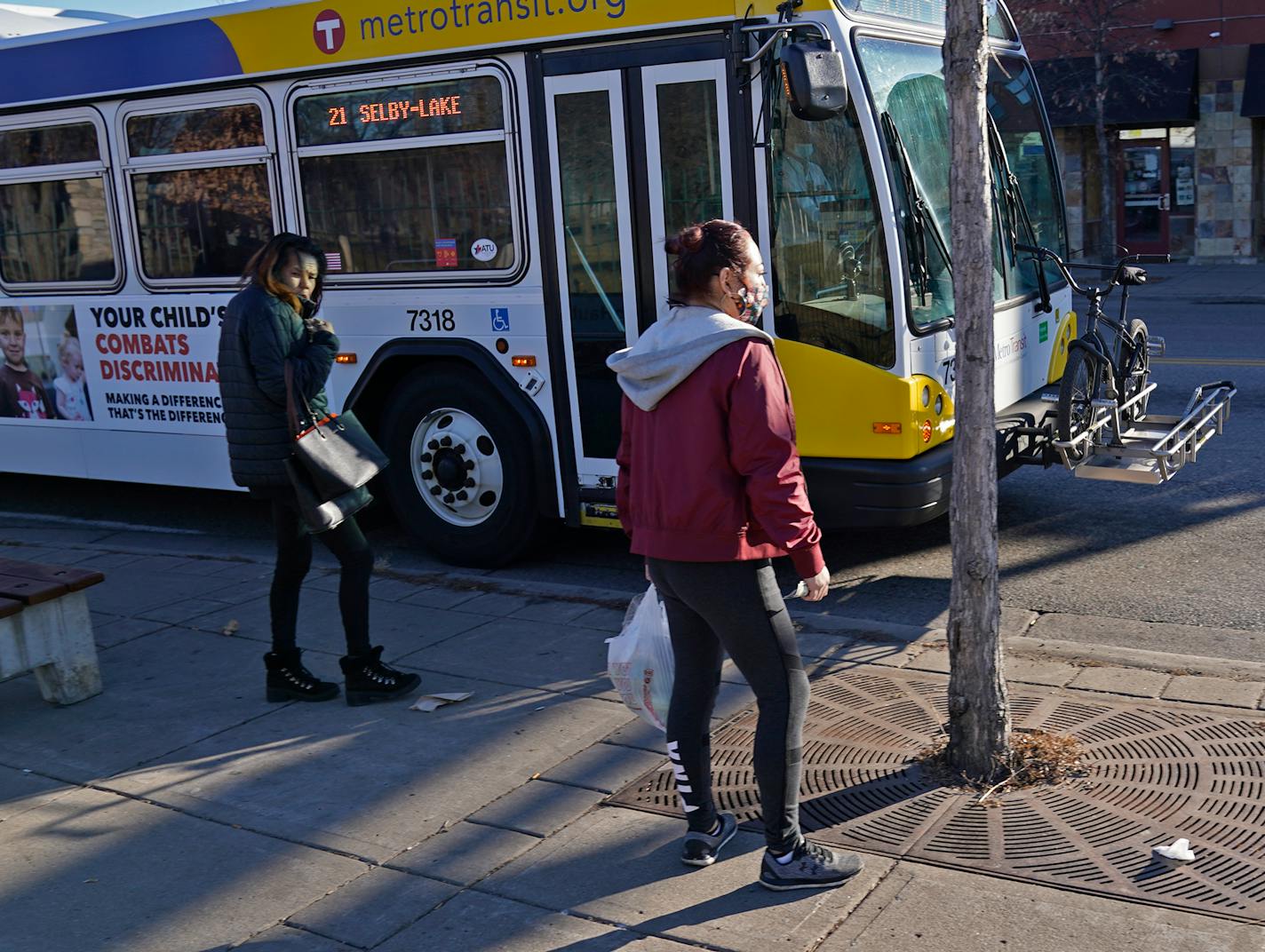 Riders prepare to board a Metro Transit route 21 bus traveling west along Lake Street at Cedar Ave. S. Wednesday in Minneapolis. ]