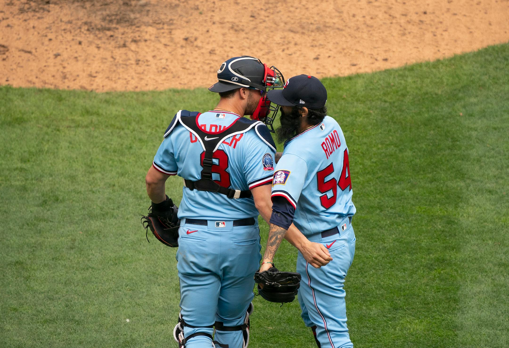 Minnesota Twins closer Sergio Romo (54) and Minnesota Twins catcher Mitch Garver (8) congratulated each other on the win after Romo struck out Cleveland Indians first baseman Carlos Santana to end the game.