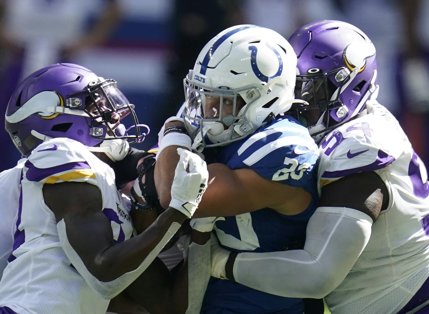 Indianapolis Colts' Jonathan Taylor (28) is tackled by Minnesota Vikings' Harrison Smith (22) and Jaleel Johnson during the second half of an NFL football game, Sunday, Sept. 20, 2020, in Indianapolis. (AP Photo/Michael Conroy)