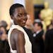 Lupita Nyong'o arrives at the Oscars on Sunday, Feb. 22, 2015, at the Dolby Theatre in Los Angeles.
