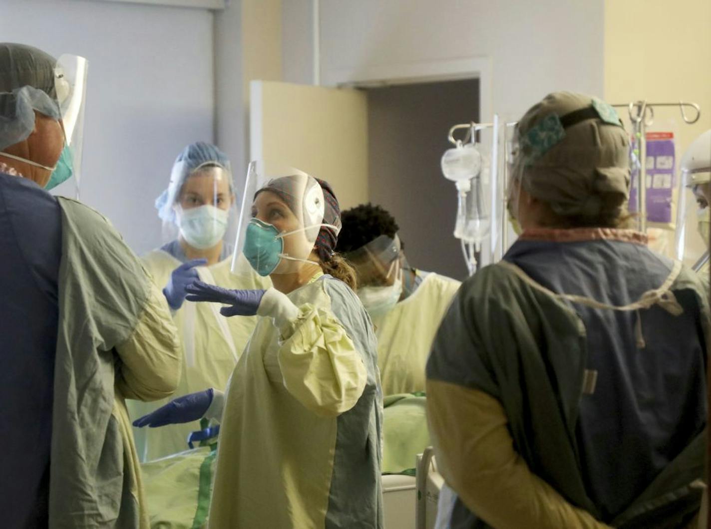 Leah Chapman, center, a registered nurse, conferred with a fellow health care worker after they rotated a COVID-19 patient in the third-floor ICU at Bethesda Hospital on on May 7. Complications from COVID-19 can make the most dangerous kinds of heart attacks even more deadly, according to a new study.