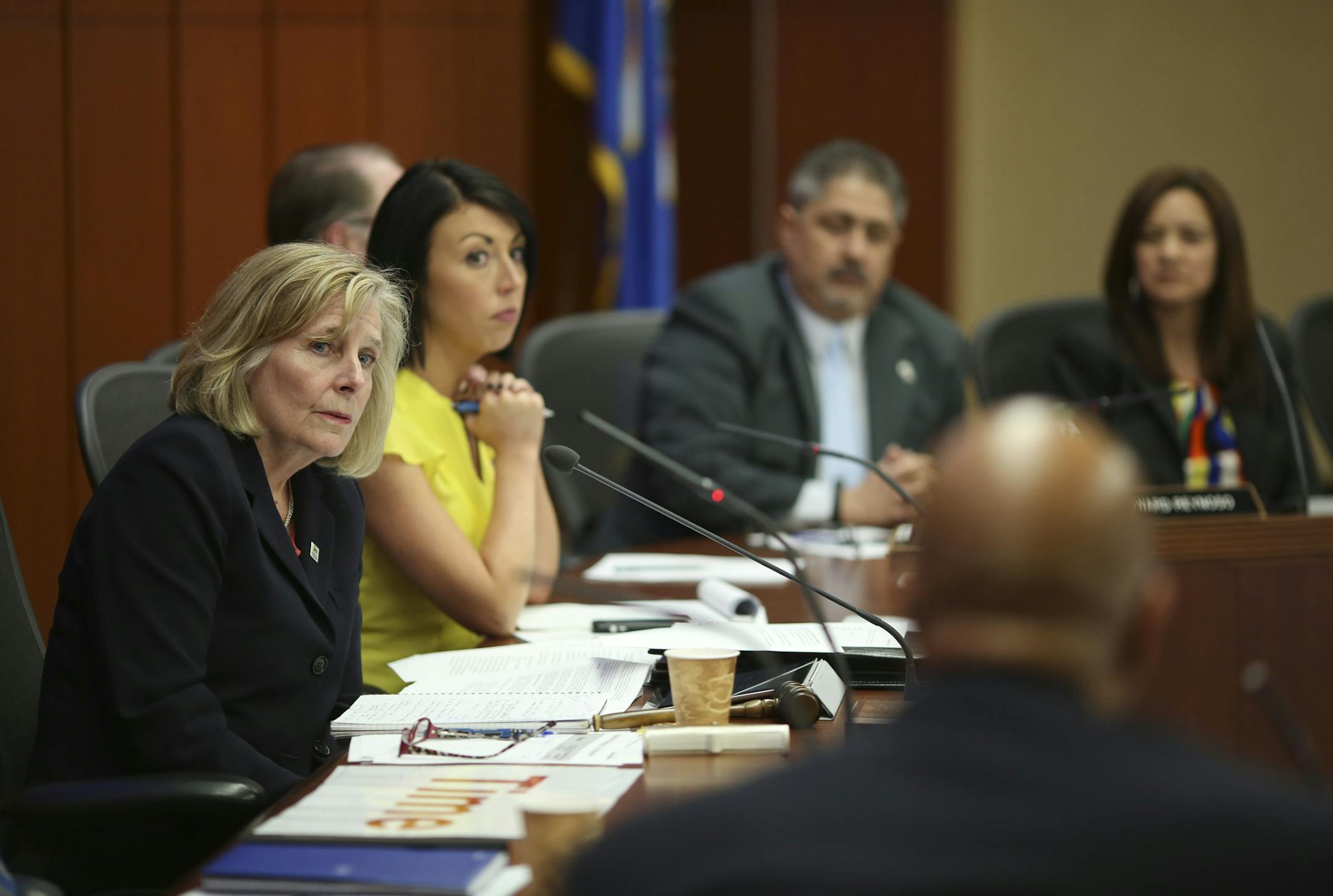 Susan Haigh, chair of the Metropolitan Council, left, listened to comments by council member Gary Cunningham before she called for a vote on the Southwest Corridor light-rail project.