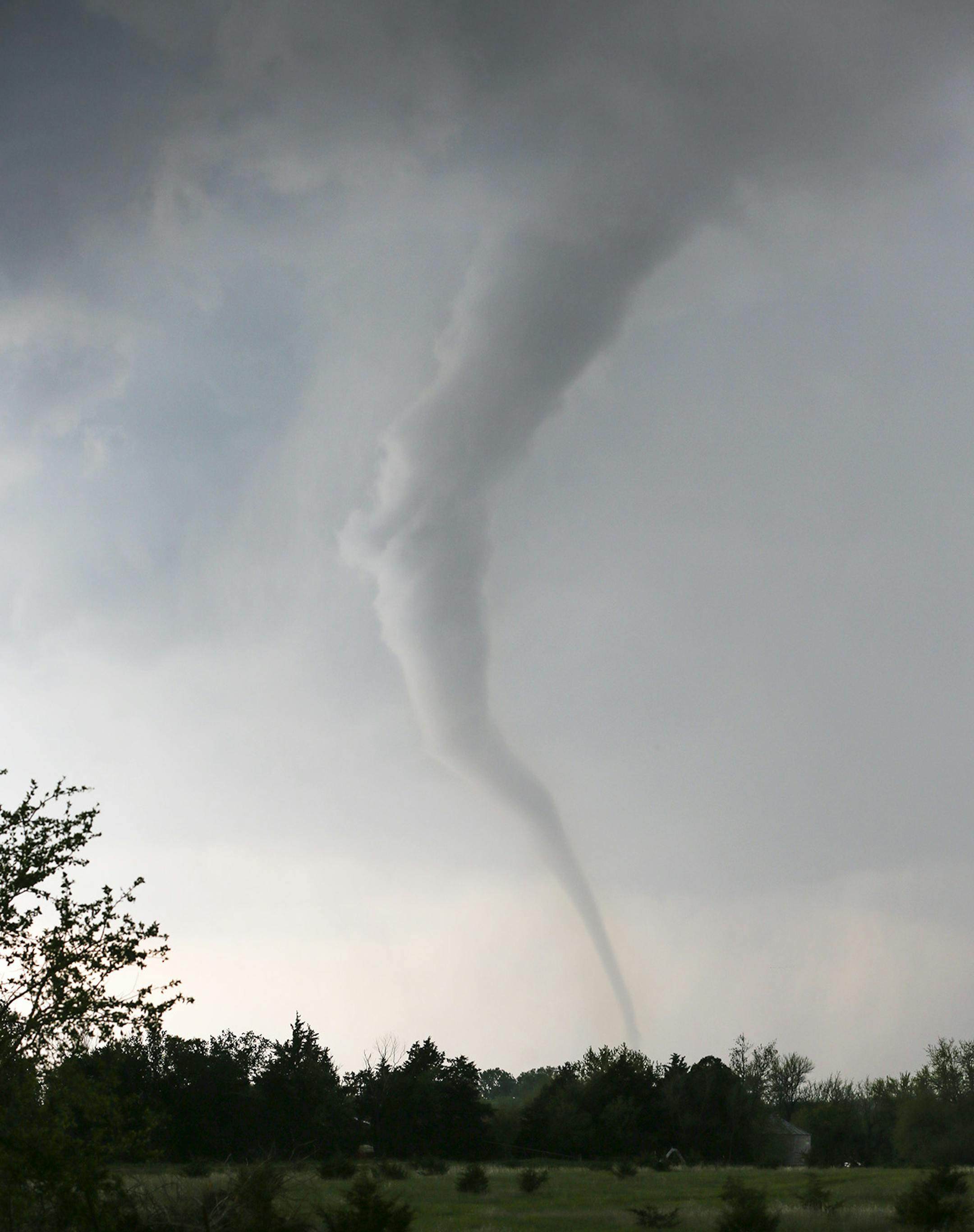A tornado touches down southwest of Wichita, Kan. near the town of Viola on Sunday, May 19, 2013. The tornado was part of a line of storms that past through the central plains on Sunday. (AP Photo/The Wichita Eagle, Travis Heying)