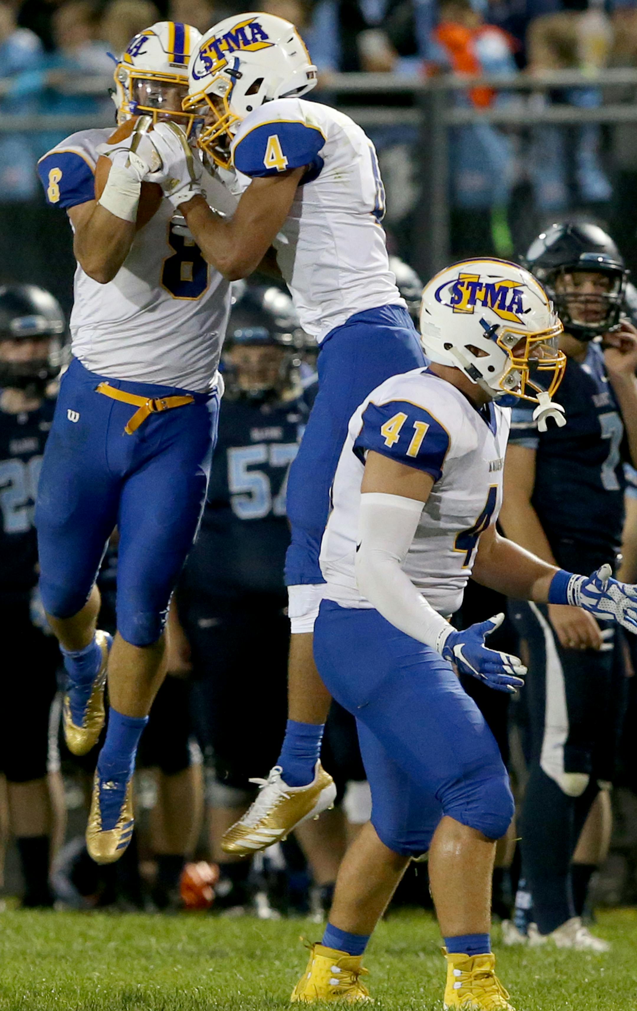 St. Michael-Albertville defender Xavier Thurman (4) celebrates with teammate Matt Feldick (8) after Feldick picked off a pass to stall a drive by Blaine during the second quarter Friday, Sept. 8, 2017, at Blaine High in Blaine, MN.] DAVID JOLES &#xef; david.joles@startribune.com Prep football