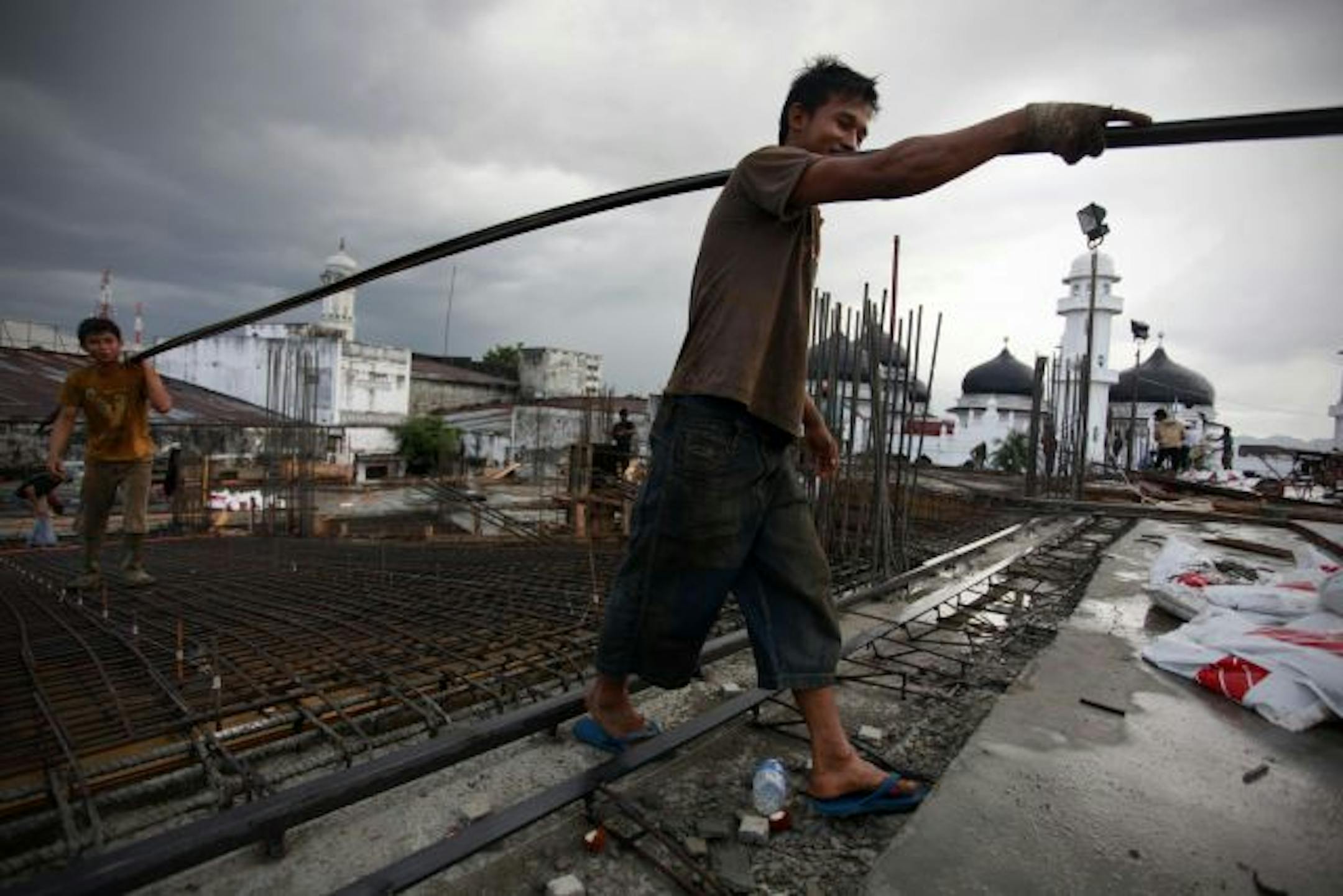 Laborers work at a construction site near Baiturrahman mosque on the fifth anniversary of the 2004 and tsunami in Banda Aceh, Indonesia.