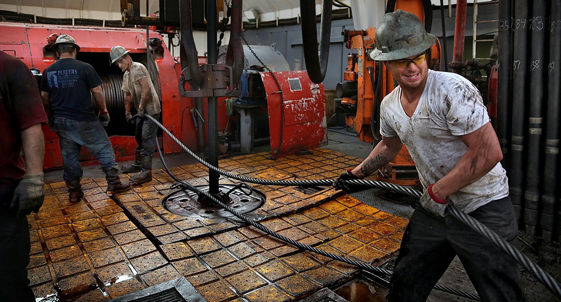 Floor hand Russell Girsh (right) guided into place before drilling began. ] (JIM GEHRZ/STAR TRIBUNE) / December 17, 2013, Watford City, ND ‚Äì BACKGROUND INFORMATION- PHOTOS FOR USE IN FINAL PART OF NORTH DAKOTA OIL BOOM PROJECT: Men work around the clock at Raven Rig No. 1 near Watford City, one of nearly 200 towering oil rigs in the Bakken. Once the rigs drill holes, several miles deep and then several miles horizontally, hydraulic fracturing technology (‚Äúfr