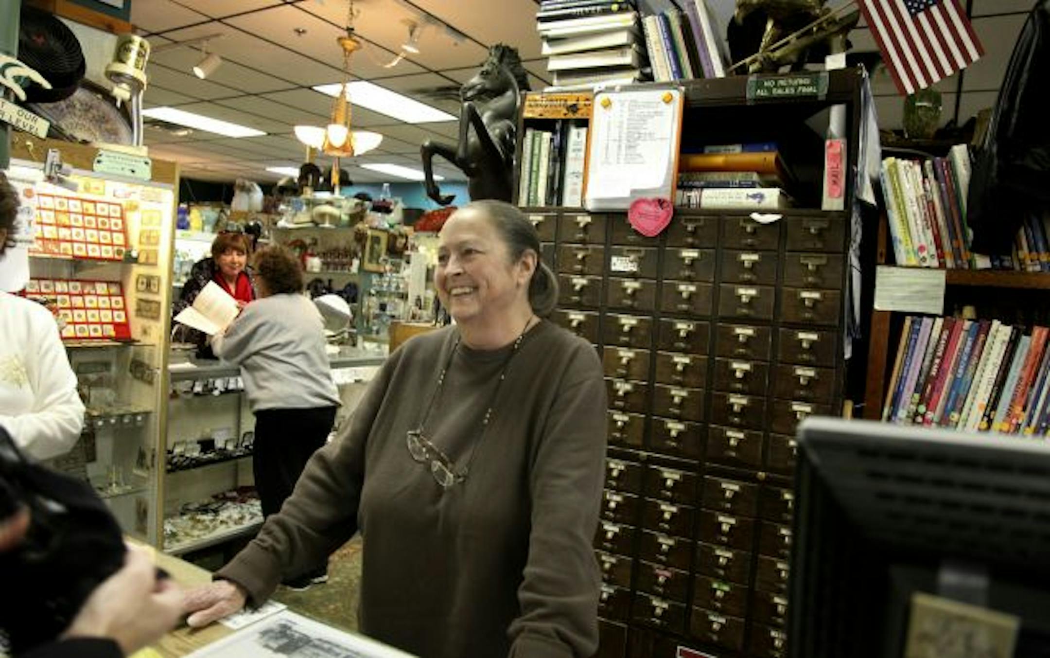 Antique toy dealer Kim Wilson chatted with customers during a sale at Antiques on Main.