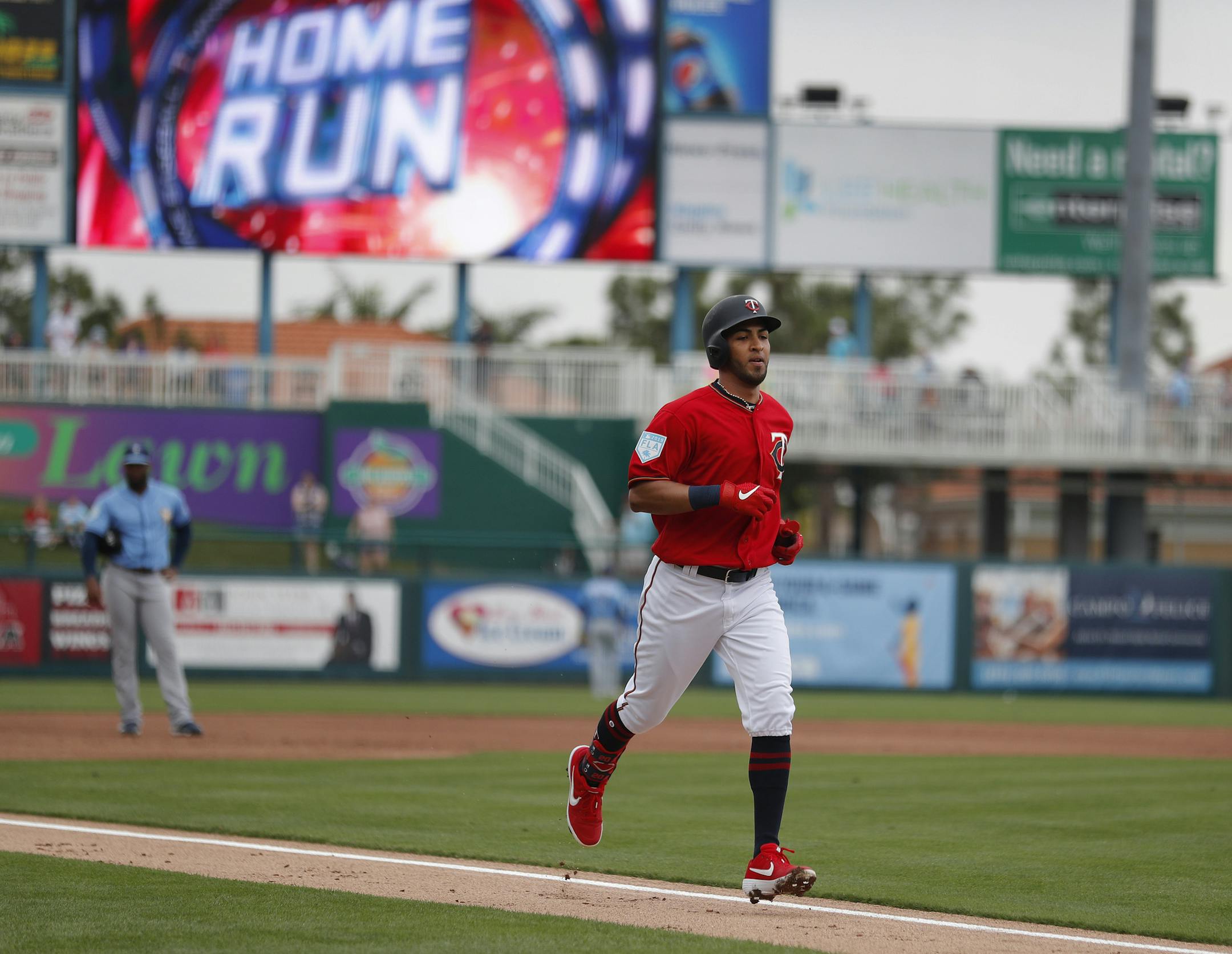 Minnesota Twins' Eddie Rosario trots home after hitting a grand slam in the first inning of a spring training baseball game against the Tampa Bay Rays, Tuesday, March 5, 2019, in Fort Myers, Fla. (AP Photo/John Bazemore)