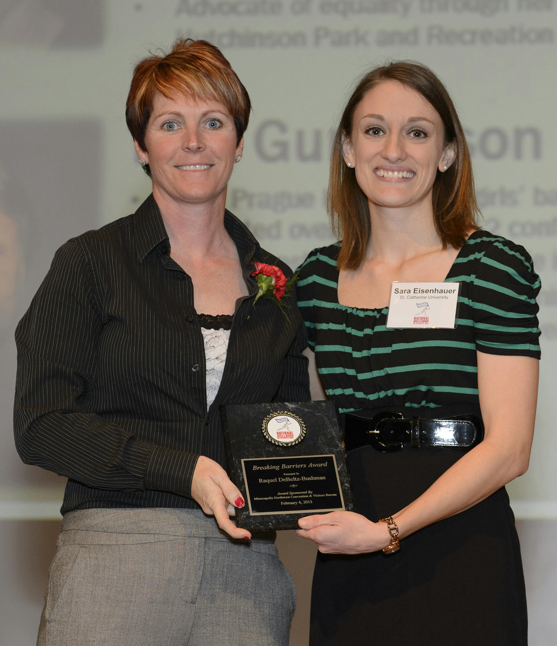 Christopher Mitchell / Special to the Star Tribune Raquel DeBeltz-Bushman, left, received a Breaking Barriers Award at the Minnesota Girls and Women in Sports Day event, from Sara Eisenhauer, SID at St. Catherine University, on the right.