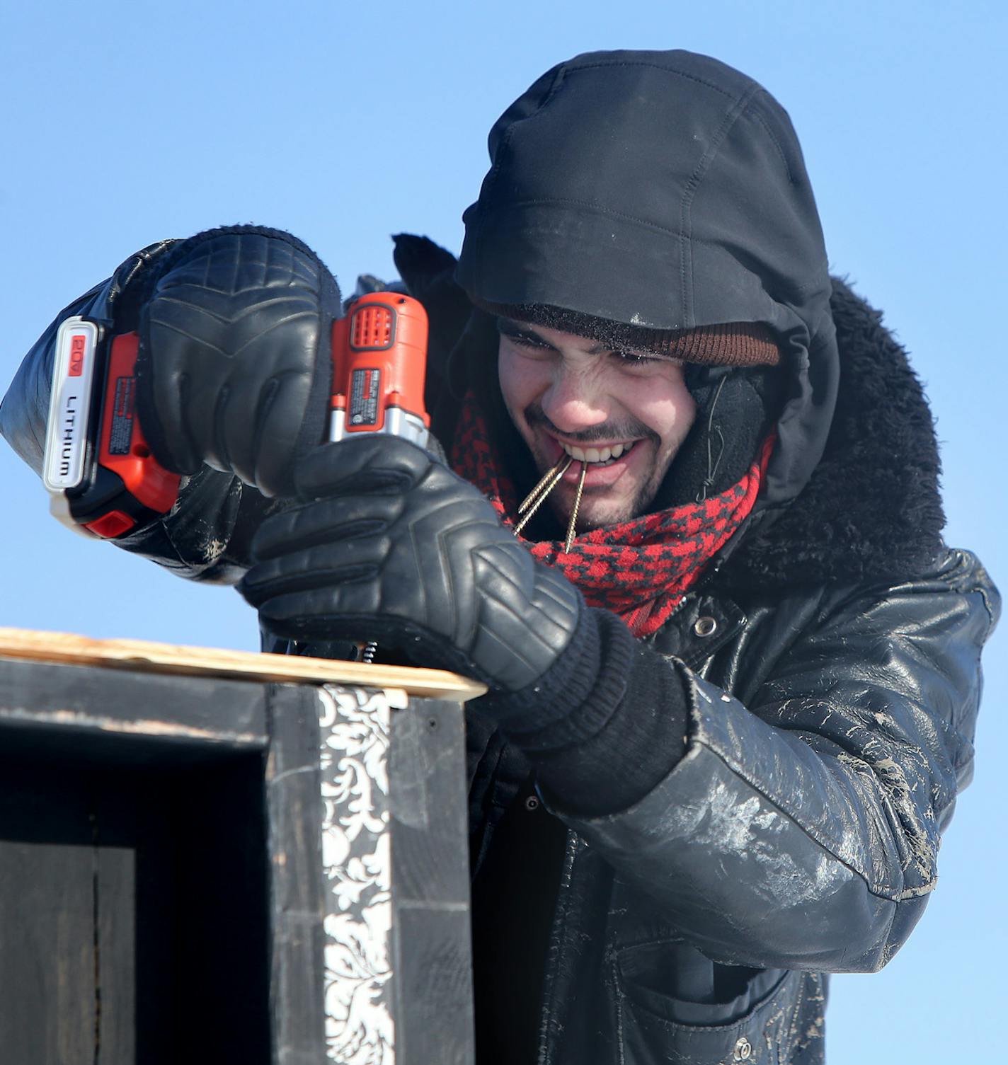 Artist Johnne Law McMahan worked on building an ice house called "Ice, Ice, Maybe" on White Bear Lake, Wednesday, January 29, 2014. (ELIZABETH FLORES/STAR TRIBUNE) ELIZABETH FLORES &#x2022; eflores@startribune.com