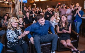 Carolyn Alt, left, planned a party at 7 Vines Vineyard and Winery in Dellwood, Minn., for her son Joe Alt, center, to watch the NFL draft. Joe's girlf