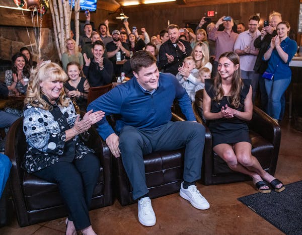 Carolyn Alt, left, planned a party at 7 Vines Vineyard and Winery in Dellwood, Minn., for her son Joe Alt, center, to watch the NFL draft. Joe's girlf