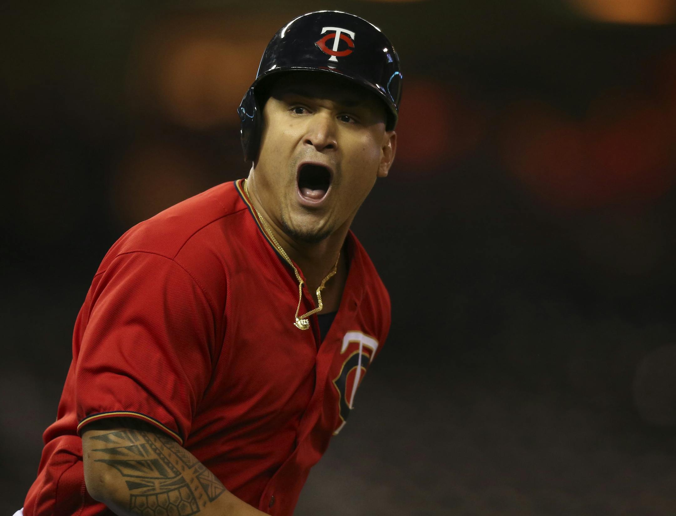 The Twins' Oswaldo Arcia shouted to his teammates in the dugout as he ran to first after hitting the walk off home run that give the Twins the win Monday night.