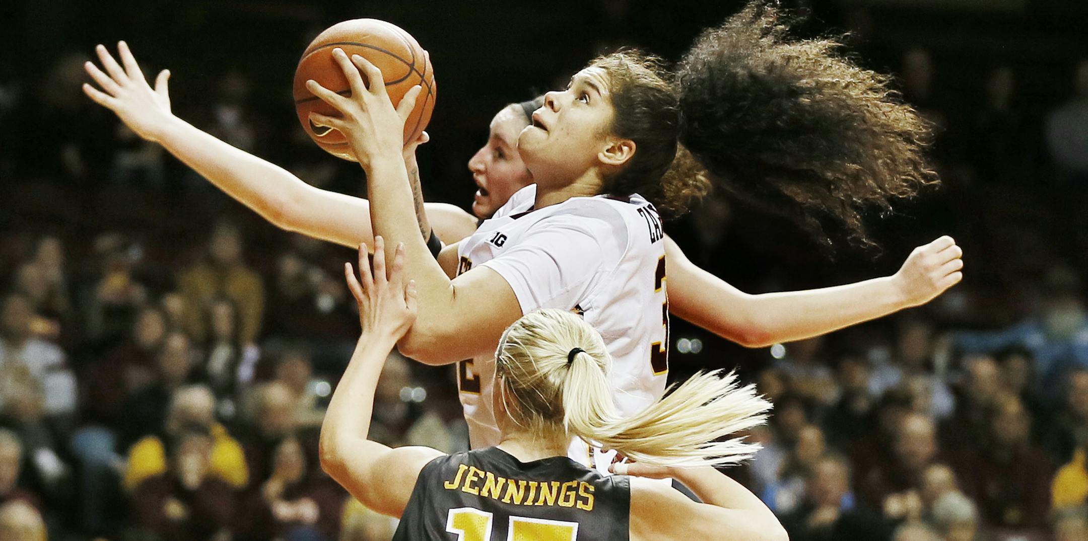 Minnesota Golden Gophers center Amanda Zahui B. (32) splits the defender Hawkeyes guard Whitney Jennings (15) and scored in the second half .Minnesota beat Iowa 93-80 at Williams Arena Tuesday February 17, 2015 in Minneapolis MN. ] Jerry Holt/ Jerry.Holt@Startribune.com