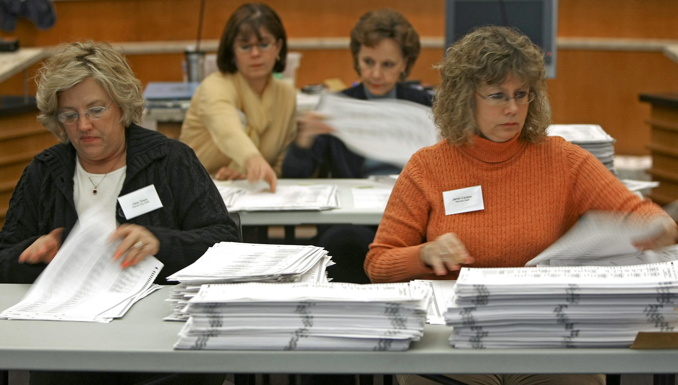 Left to right, Jane Timm, Mary Hartuppee, Marce Jost and Janet Canton were among the officials recounting the ballots Thursday in the Edina City Council race between Mary Brindle and Josh Sprague. Only 130 votes separated the candidates out of 31,512 votes cast, triggering the recount.