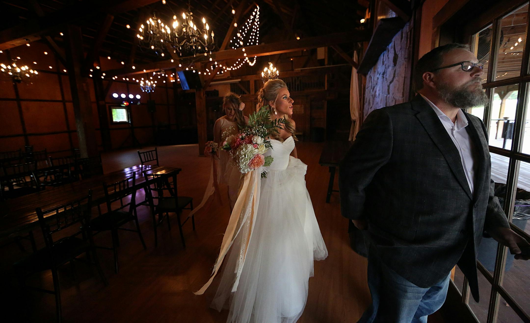 Bride Savannah Koehnen waited with her father, Gary Koehnen, as the two prepared to walk up the aisle. At left is Savannah�s sister, Paige.