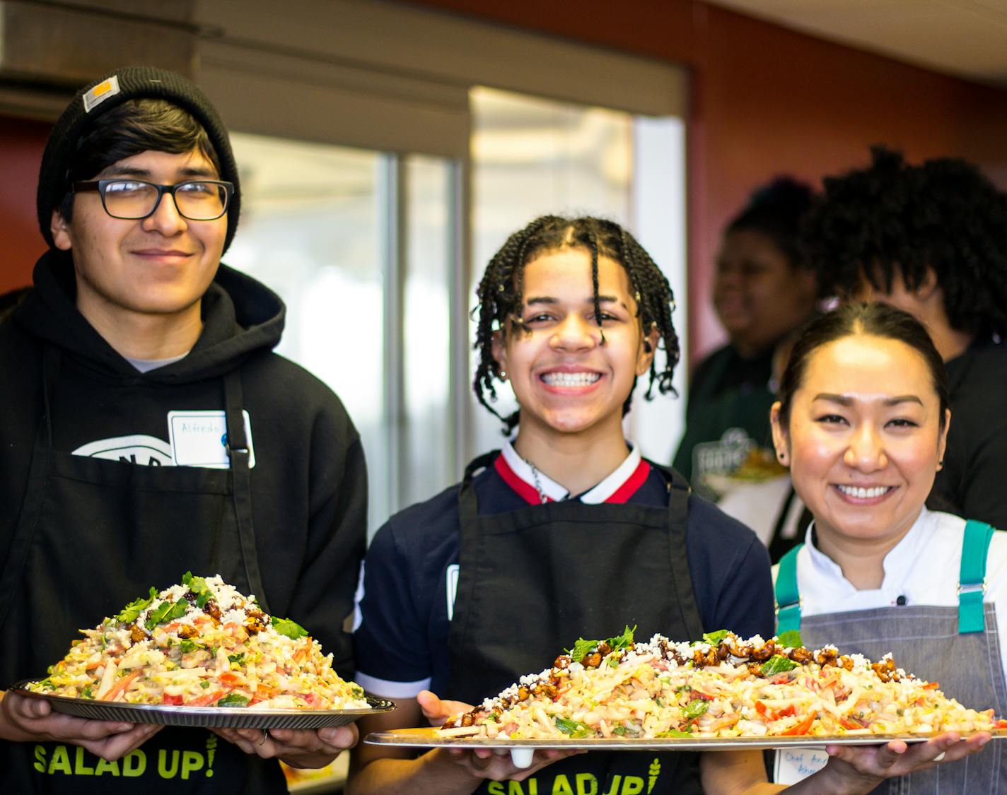 Roots for the Home Team/Urban Roots student workers Alfredo, Marquise and Chef Ann Ahmed , owner of Lat14 and Lemon Grass Thai. They displayed their "MTV" salad, or "Mexico to Vietnam," representative of the heritage of the teenage chefs, at an event earlier this year. Photo: Roots for the Home Team