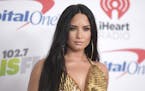 FILE - In this Dec. 1, 2017 file photo, Demi Lovato arrives at Jingle Ball at The Forum in Inglewood, Calif. Lovato celebrated six years sober at a co