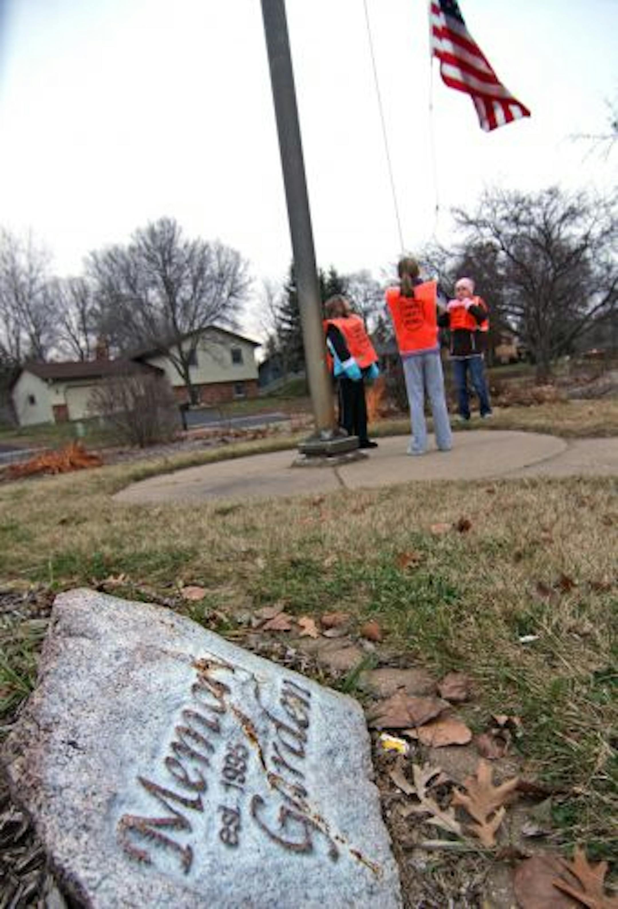 Sand Creek fifth-grade patrol members Ashley Tyson, Maddison Giorgi and Megan Langworthy raised the U.S. flag, which is in the center of a garden dedicated to the memory of children who died while students.