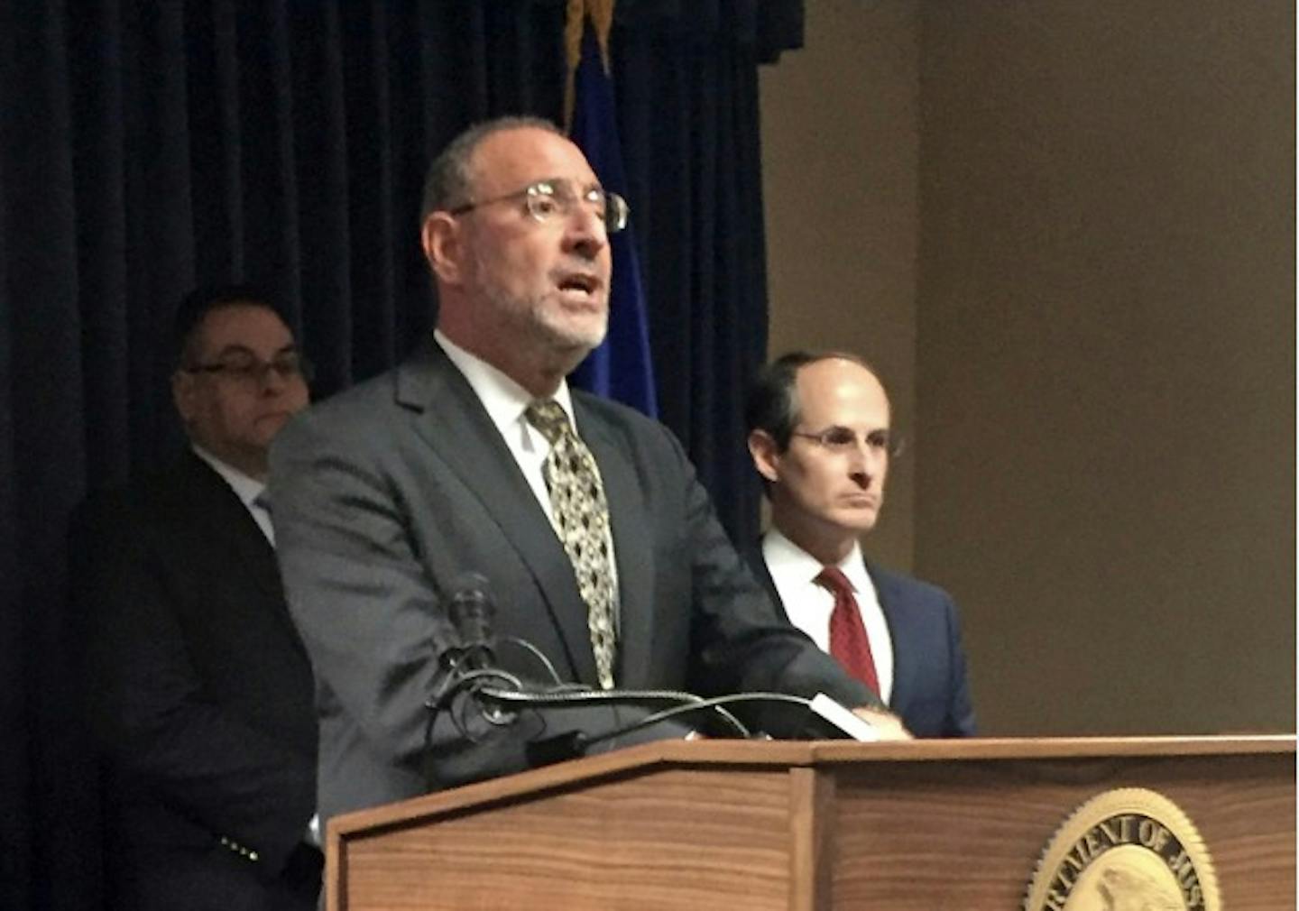 U.S. Attorney Andrew Luger, left, announces Wednesday, Dec. 21, 2016, in Minneapolis that federal authorities in Minnesota have charged 21 people with conspiracy to commit health care fraud in what they describe as separate scams by six chiropractors that defrauded auto insurance companies out of more than $20 million. Listening at right is Minnesota Commerce Commishioner Mike Rothman.