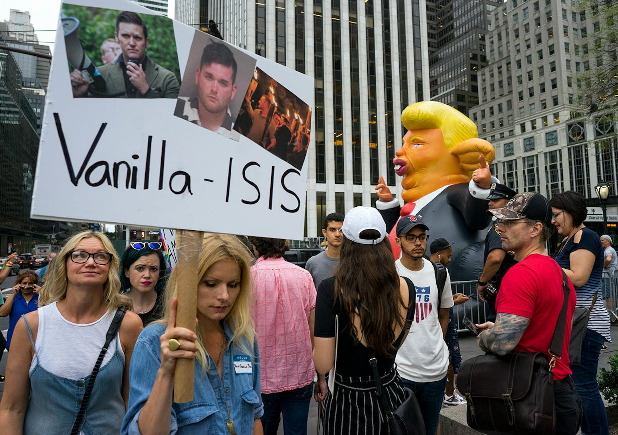 Protestors gather at 59th Street and 5th Avenue in New York, Monday, Aug. 14, 2017, as they protest not far from Trump Tower.