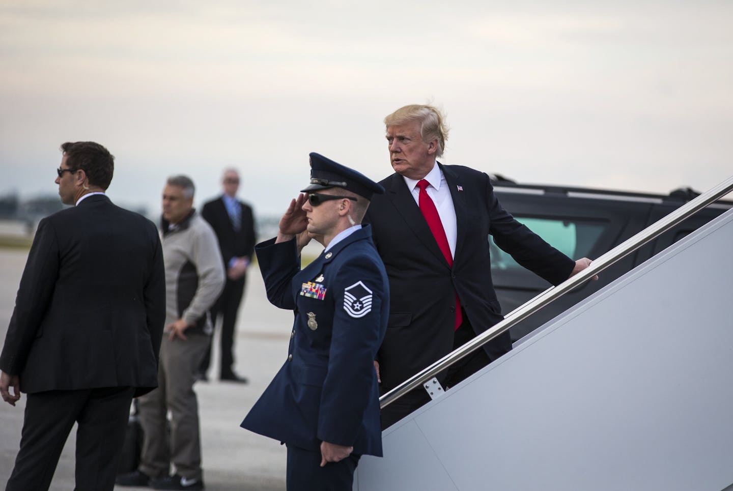 President Donald Trump boards Air Force One at Palm Beach International Airport in West Palm Beach, Fla., Jan. 1, 2018. Trump&#xed;s linkage of the anti-government protests in Iran with the nuclear deal suggested he could feel compelled to re-impose sanctions against the country when he faces the next deadline on the matter later this month. (Al Drago/The New York Times)